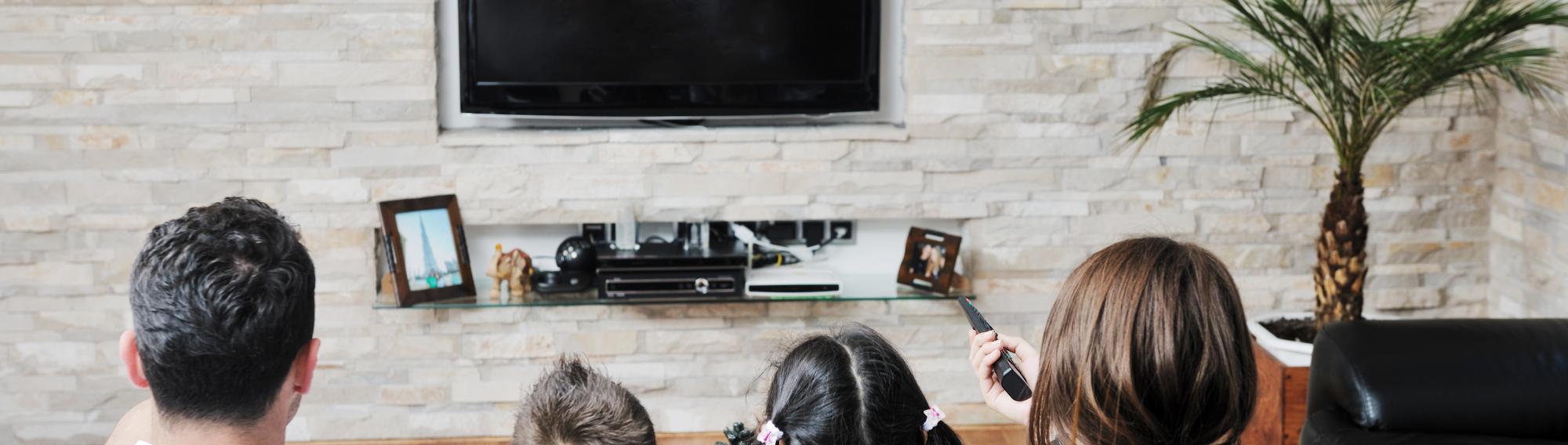 Image of living room with an affordable tv being used by a family